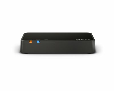 The Oticon TV adapter 3.0 is a black, rectangular device with orange and blue indicator lights and the Oticon logo on the top right, shown on a plain white background.