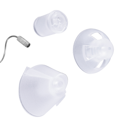 Close-up of three translucent silicone hearing aid domes—including the Standard Dome RIE (NP/LP)—and a thin metal tube on a white background, highlighting different shapes and sizes for ear fittings.